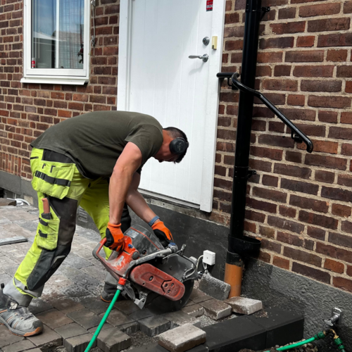 Karlssons Stensättning utför precisionskapning av marksten vid entré till villa med tegelfasad