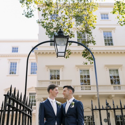 Two men looking at each other under an arch