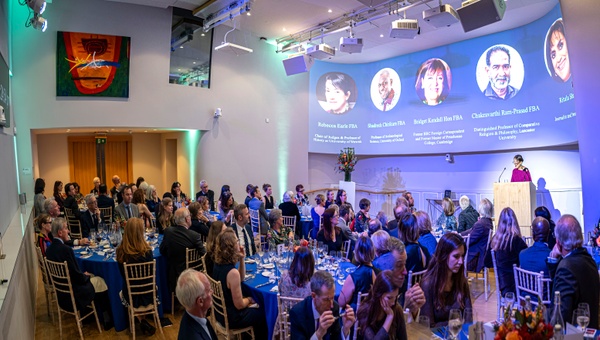 A private dining set up in the SHAPE Room, with guests seated at round tables