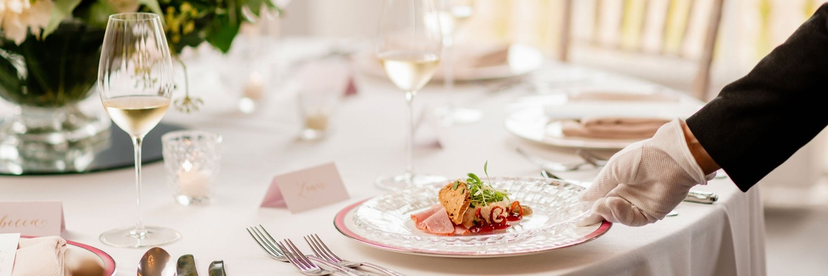 A private dining dish served on a white plate with cutlery next to it