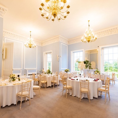 A dinner set-up on round tables in the Beatrice Webb Room