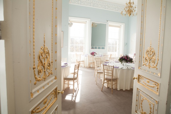 A wedding breakfast cabaret style in a bright light blue room with gold coving designs