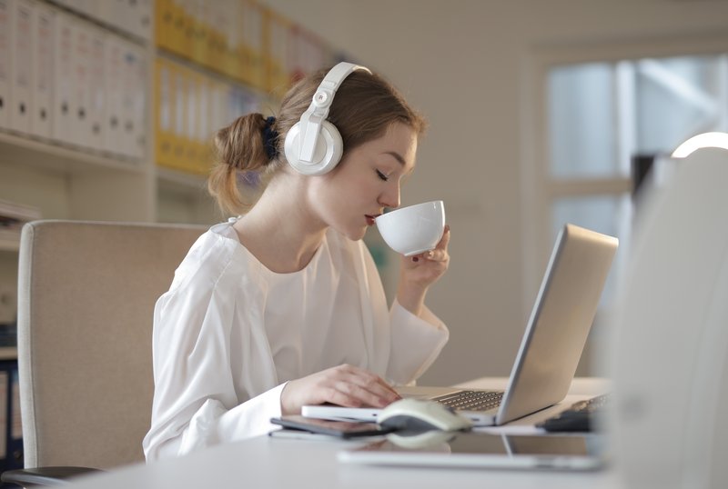 drinking coffee and working on laptop in relaxed atmosphere