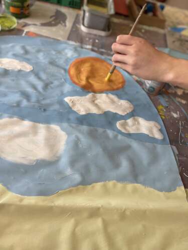 A sun from the final mural being painted as a practice