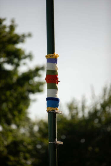 a 'yarn bombed' lamp post wrapped with colourful knitted fabric