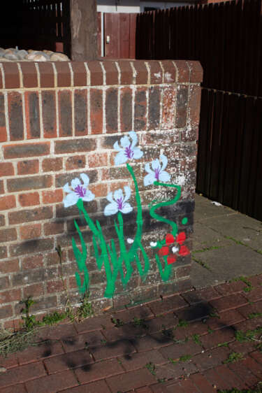 flowers painted onto a low brick wall
