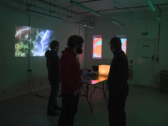 Projections of colourful patterns on the walls in a dark room