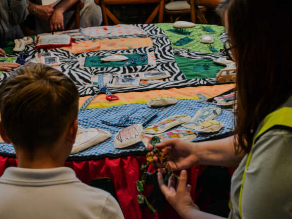 A young person and an adult working on creative craft making