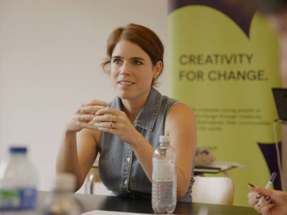 Princess Eugenie sits at a table with the Artswork banner behind her, which reads 'Creativity for change'.