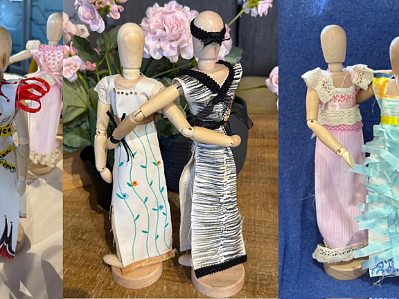 three images side by side: small wooden mannequin wearing white fabric fashioned into a dress with red ribbons and spiky patterns and yellow ribbon with black text to look like crime scene tape around the waist, two mannequins arranged with dresses crafted from fabric in black and white, two mannequins with pink and blue dresses decorated with lace and ribbons