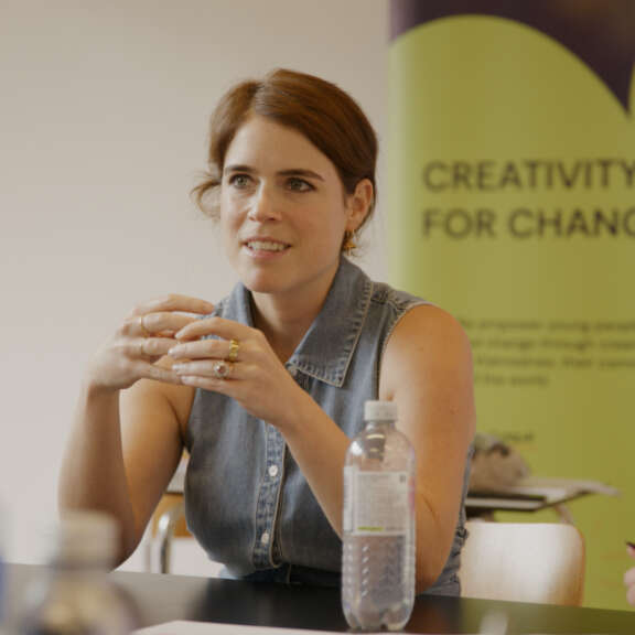 Princess Eugenie sits at a table with the Artswork banner behind her, which reads 'Creativity for change'.