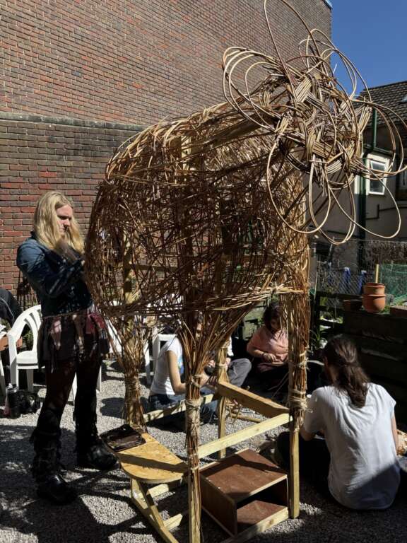 A free-standing bio sculpture made from willow, with a flower shape at the top