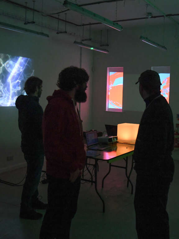 Projections of colourful patterns on the walls in a dark room