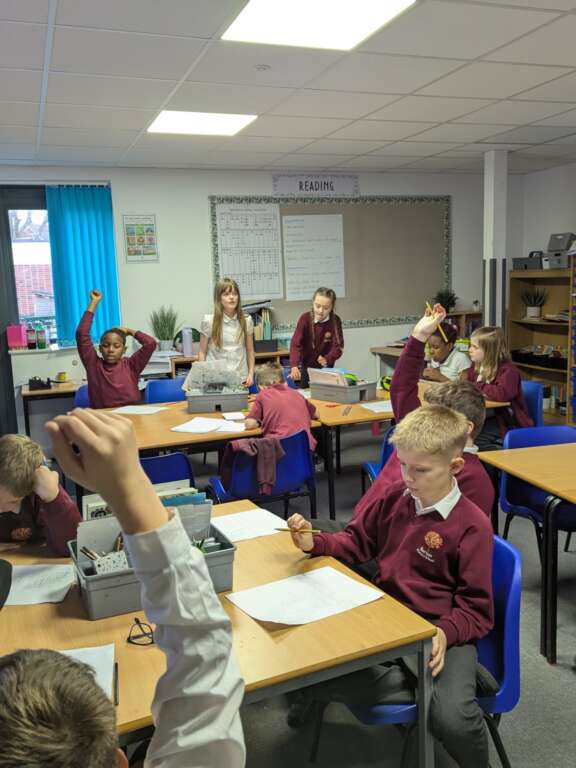 Classroom of year 5 pupils engaging with creative facilitator