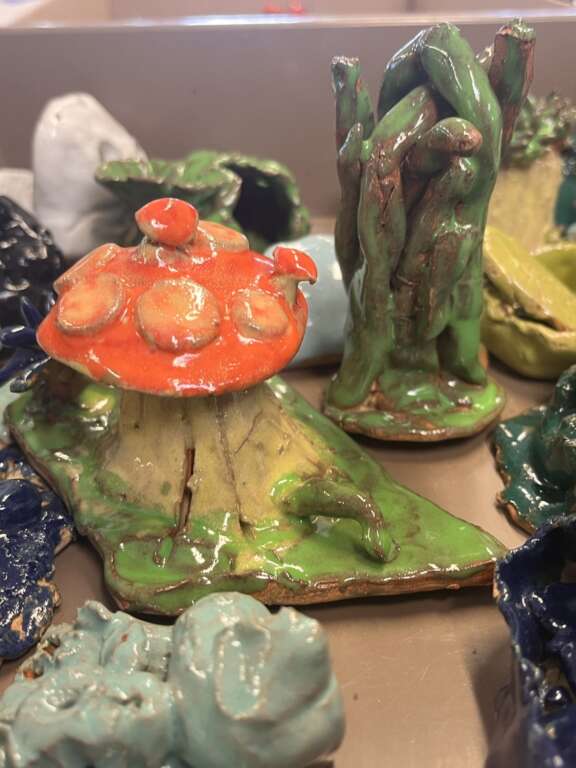 close up image of an array of abstract ceramic forms with brightly coloured glaze and lots of varying shapes and textures