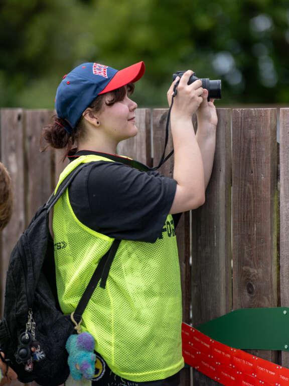 a young girl taking a photograph