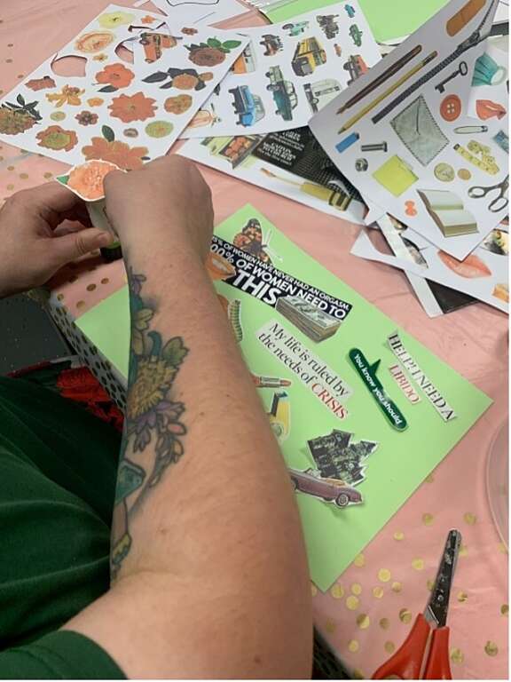 Young persons hands working on a collage