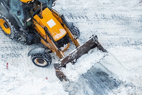 Tractor loader machine uploading dirty snow into d 2023 11 27 05 16 20 utc