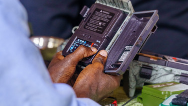 An close up of an opened audio moth, cupped between two hands