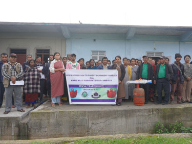 A group of people outside a building with a sign