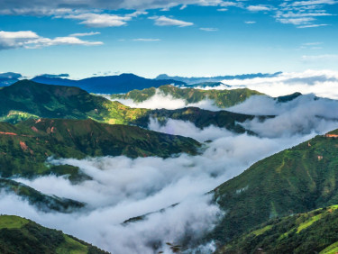 Clouds collecting over the green hills of Ecuador
