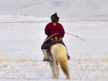 A person on a horse with a bow in a snowy landscape