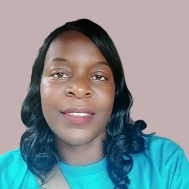 A woman in a turquoise top in front of a taupe wall