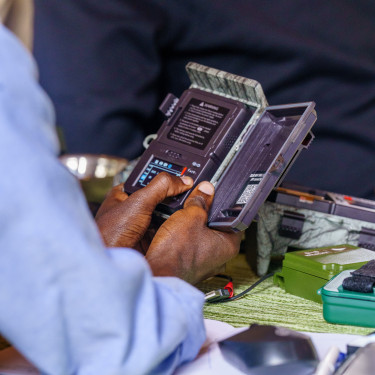 An close up of an opened audio moth, cupped between two hands