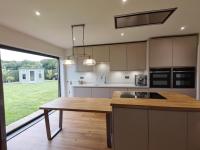 Design, supply and remodel of this kitchen in Holt incorporating our Airo oak veneer horizontally grained J-pull door painted in Cashmere Matt finish. Oak block island and dining table alongside Carrara quartz worktops and mid oak LVT flooring. #kitchendesign #kitchens #design #designer #interiors #interiordesign #oak #quartz #cashmere #carpentry #carpenter #furniture #bespoke #norfolk #norwich #horsford