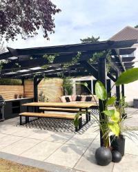 Pergola & outdoor kitchen REVEAL! 

Here it is, just in time for… oh… wait… 🤦🏽‍♀️ the end of summer 🙄🤷🏽‍♀️😂🤣. True to form, I’ve (almost) finished; just a season too late 😊😂. 

Still to do: kitchen 2nd coat, microcement the worktop, finish sofa base, build the coffee table, hang a few bits and get a lounge chair & bigger rugs… but I couldn’t wait any longer to show you! (Knowing me, the finishing touches may take some time 😬🤣)

It’s only 1.5 years since we cut down the trees, ready to extend the patio for this to go on!! 

Thanks to coyne_design_and_build_ltd for helping me change the roof design so the husband could fit under it 🤣 and build this 7.5m x 4.5m beast in scorchio conditions! 

What do you think? I’ll be posting more details in the coming days & weeks - particularly on my DIY table and benches (thehairpinlegco PR gifted) & outdoor sofa - but ask me anything below, I’ll be happy to help. 

Also swipe to see the before #transformationtuesday 

#pergola #outdoorkitchen #outdoorkitchens #outdoorkitchenproject #gardenstructure #largepergola #summervibes #summerdesign #outdoordesignideas #outdoorlounge #outdoorliving #outdoorinspiration #outdoorinspo #woodenpergola #woodenstructure #timberframe #largediningtable #outdoordiningtable #diytable #tableandbenches