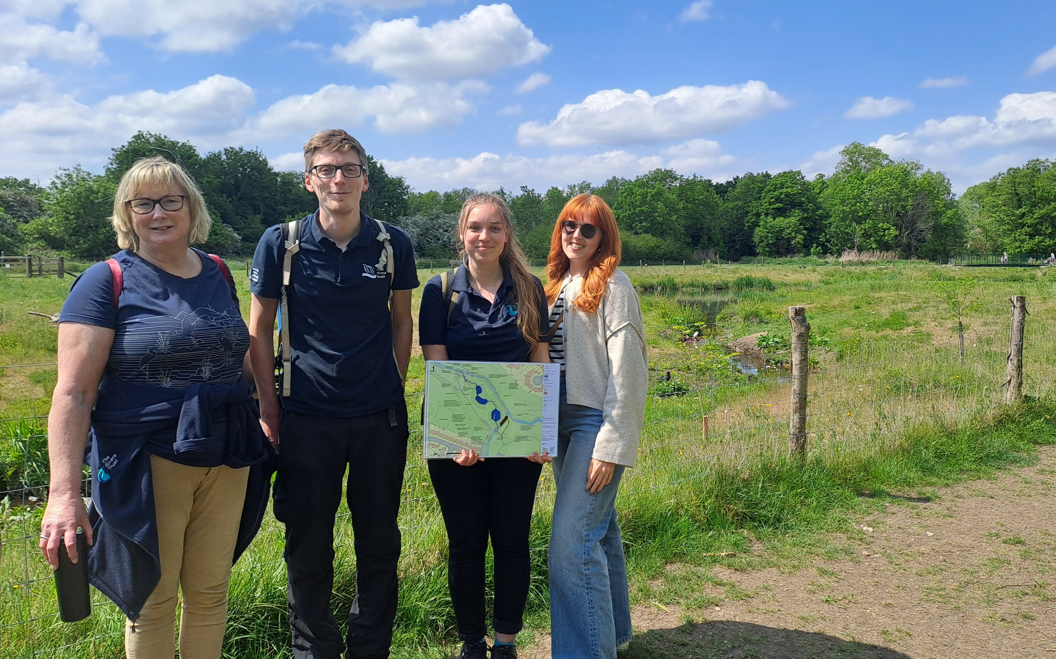 3 people in front of a wetland