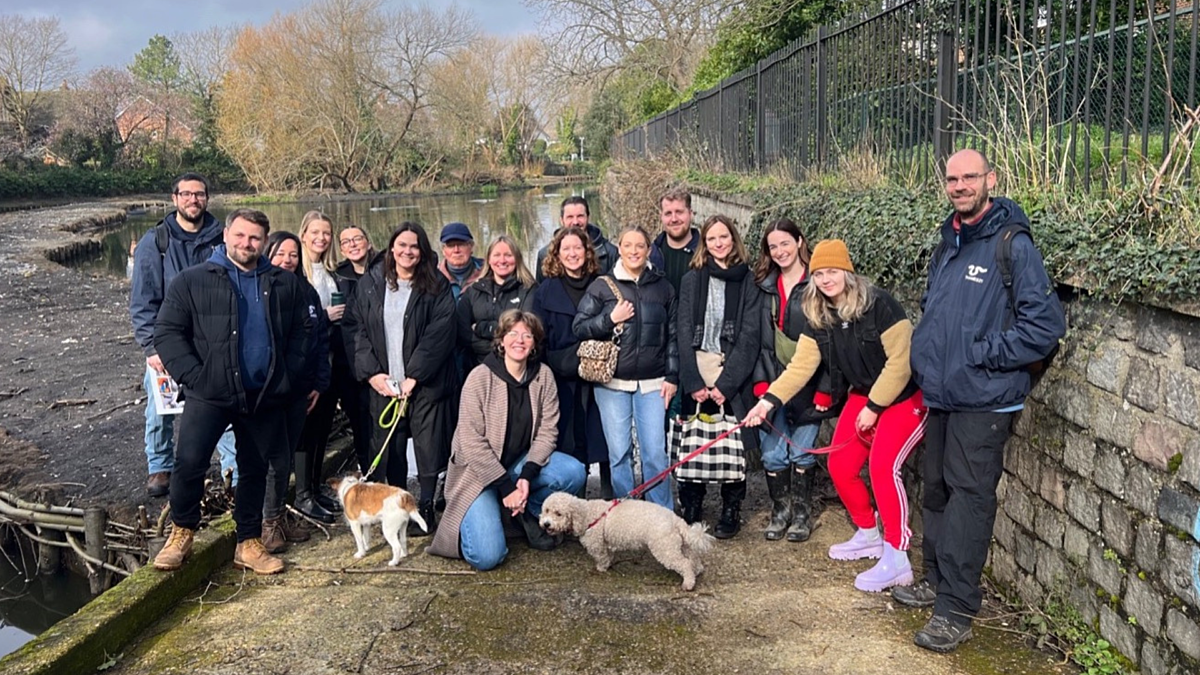 Belu team photo in front of a pond