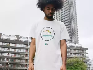 Man in Rivers Trust T-shirt white with swimmer illustration