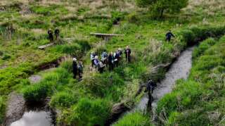 Ariel view of a group of people stood next to a river