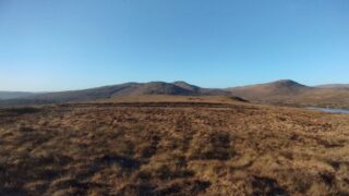 View across a peatland with hills in the background