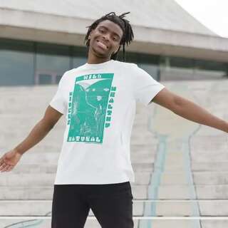 A smiling man wears a white teeshirt with a bold blue design