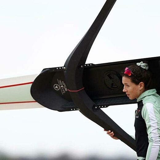 A young woman holds a rowing boat