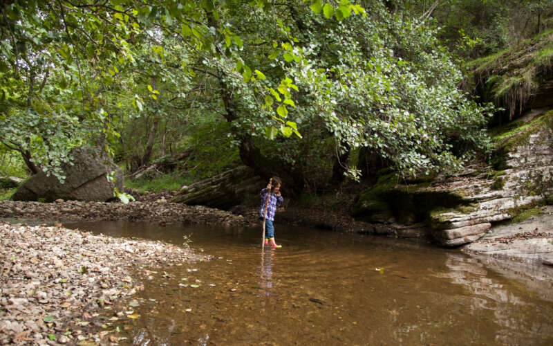 Young girl playing in river