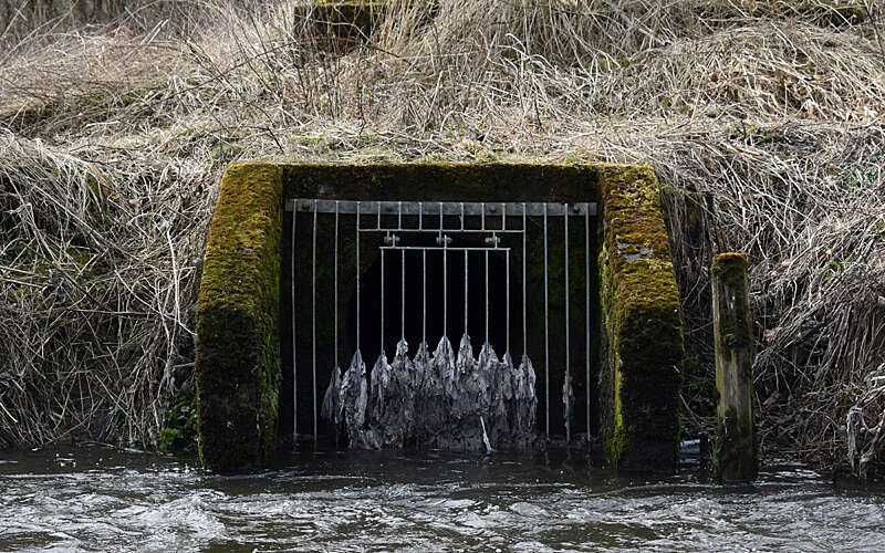 Sewage outfall blocked by wet wipes leading into river