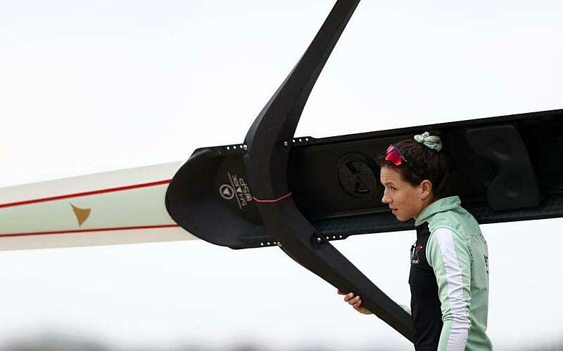 A young woman holds a rowing boat