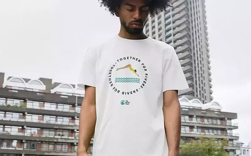 Man in Rivers Trust T-shirt white with swimmer illustration