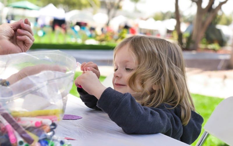 Young girl doing craft activities outside