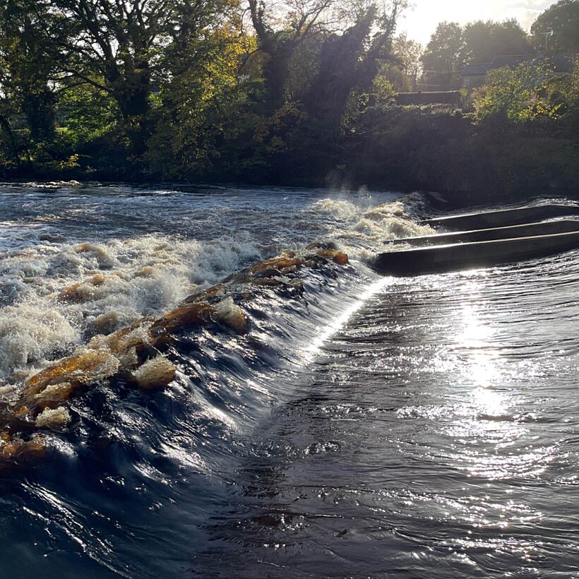 Barrier in a river with a fish pass installed