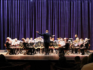 Allerton Brass in concert in front of a blue curtain