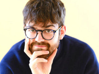 A photograph of William Bracken looking at the camera