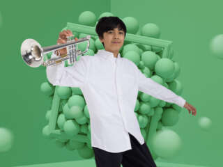 Catalyst young trumpet player on a green background