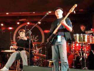 Jah Wobble and band play on stage