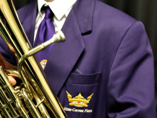 Close up of a student playing the french horn