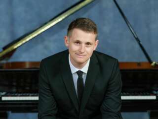 Man in front of a piano