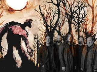 a photograph of the band Ilumetris, with an illustrated monster and landscape